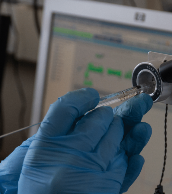 Hands doing a procedure in lab.